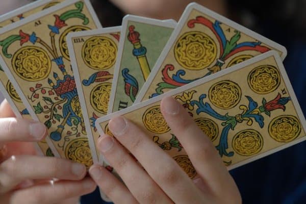 A girl holding tarot cards in her hands