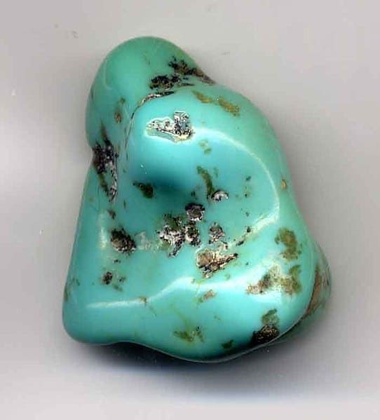 Turquoise pebble, made by tumbling the rough rock in a rotating drum with abrasive.