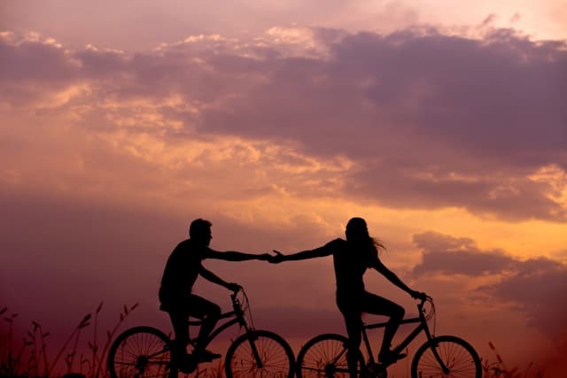 A couple riding bicycle